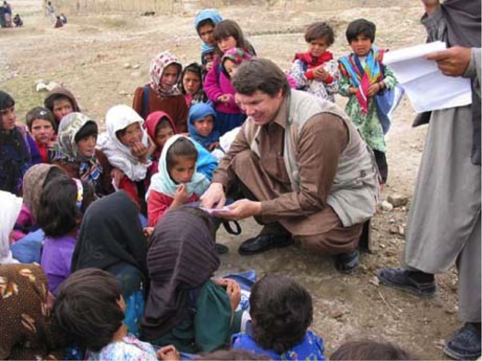 GREG MORTENSON with some children in Pakistan (Photo courtesy of: CAI)